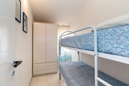 a bedroom with two bunk beds and a doorway at Vista Corsica in Isola Rossa