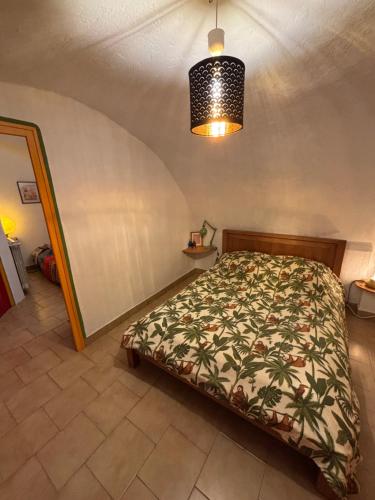 a bedroom with a bed in a room at Longo maï in Vallon-Pont-dʼArc