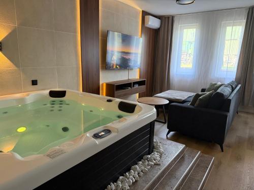 a living room with a large jacuzzi tub at Heaven SPA Eger in Eger