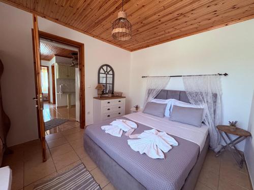 a bedroom with a bed with towels on it at Dream house Villa in Alyki