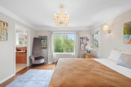 a bedroom with a large bed and a chandelier at Royalty B&B in Richmond