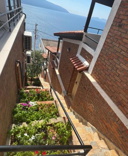 a stairway with flowers and plants on a building at Hotel Kappa3 Villas in Vlorë