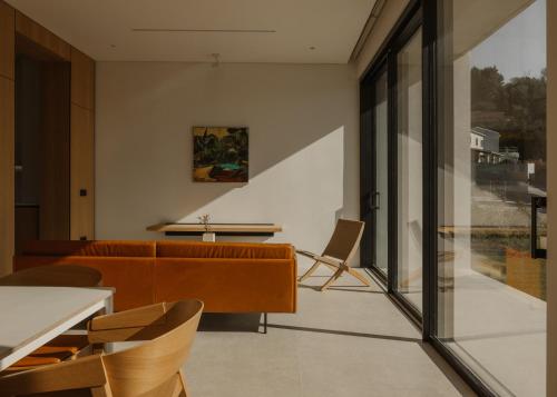 a room with a couch and chairs and a table at The Habitus Residence, a Design house in Corfu