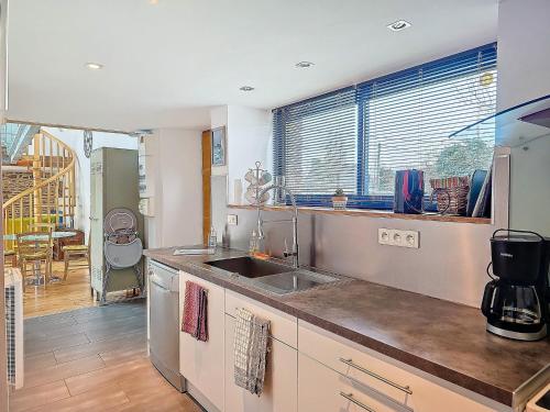 a kitchen with a sink and a counter top at Ty Heole House in Plouézec