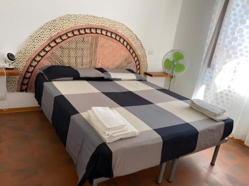a bedroom with a large bed with a blue and gray blanket at Casa Marel in Stromboli