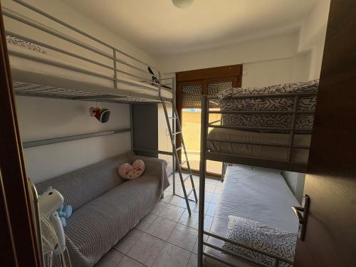 a bedroom with two bunk beds and a ladder at Afytos Family Apartment in Afitos
