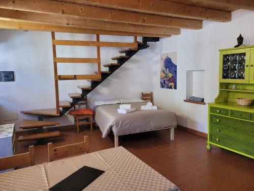 a bedroom with a bed and a staircase in a room at Casa Sole in Ceniga