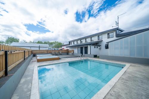 a swimming pool in the backyard of a house at Bakkaflöt Guesthouse in Varmahlid