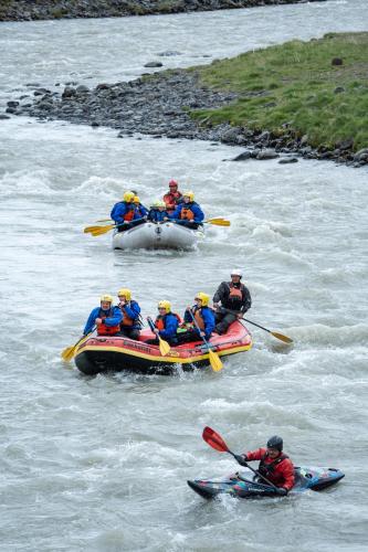 a group of people in kayaks on a river at Bakkaflöt Guesthouse in Varmahlid
