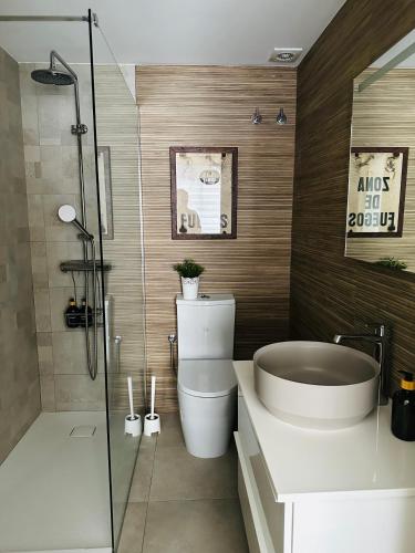 a bathroom with a toilet and a sink and a shower at Casa Roa in Altea