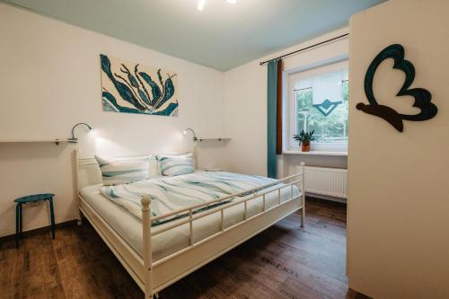 a bedroom with a bed and a window at Ferienhaus Napoleon in Waldmünchen