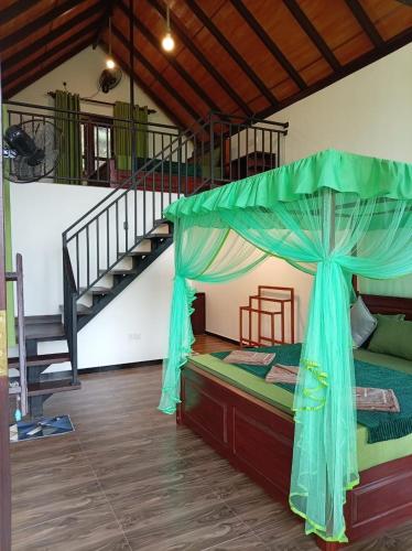 a bedroom with a bed with a canopy and a staircase at Rainforest Nature Resort - Sinharaja in Deniyaya