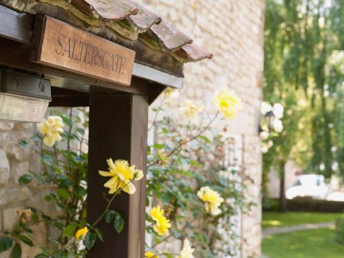 a sign for a garden with yellow flowers in front of a building at Saltersgate in Pickering