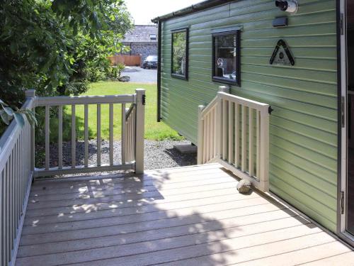 a wooden ramp leading to a green house at Sarnfaen Static - Uk52097 in Llanddwywe