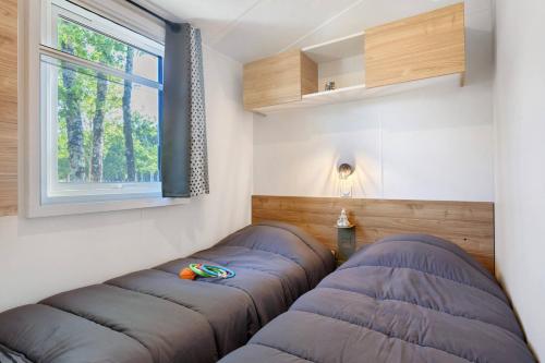 two bean bags in a room with a window at Mobilehome Evasion 46 in Saint-Gervais