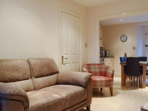 a living room with a couch and a table at Esthwaite in Windermere