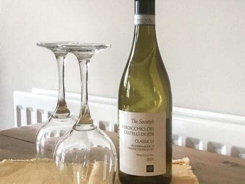 a bottle of wine and two wine glasses on a table at Ebba's Neuk in Beadnell