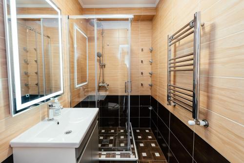 a bathroom with a sink and a shower at Apart Hotel Anastasia in Chişinău