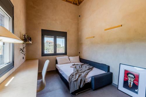 a small bedroom with a bed and a window at Terra Rossa in Plytra