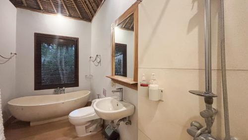 a white bathroom with a tub and a sink and a bath tub at Amara Giri Ubud View Villas in Ubud