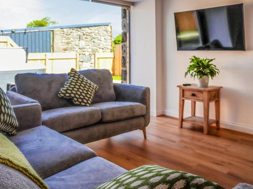 a living room with a couch and a table at Erddyn - Uk48860 in Llanddwywe