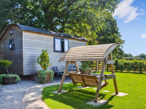 a swing in front of a tiny house at Morning Mist in Strensall
