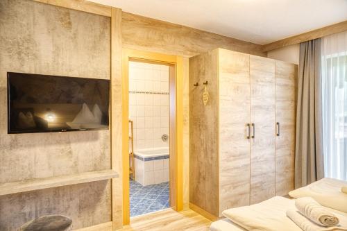 a bathroom with a bed and a shower and a tub at Appartements Spitaler in Ried im Zillertal