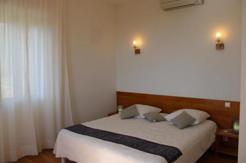 a bedroom with a bed with two pillows on it at La bastide in Vallauris