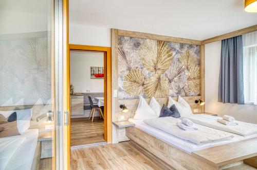 a hotel room with a bed and a mirror at Appartements Spitaler in Ried im Zillertal