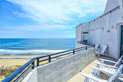a balcony with two white chairs and the ocean at Pyramid 10C in Ocean City