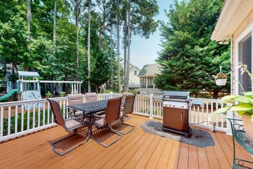 a deck with a table and chairs and a grill at The Point 1437 in Ocean Pines