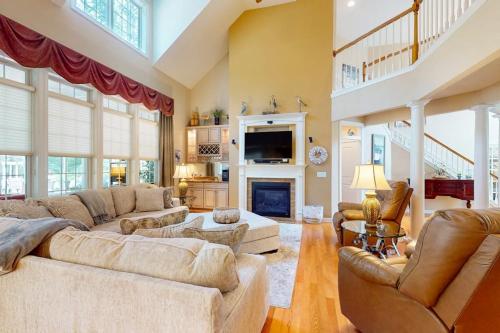a large living room with couches and a fireplace at The Point 1437 in Ocean Pines