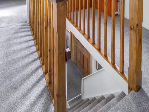 an overhead view of a stairway with wooden rails at Needle Cottage in Cullen