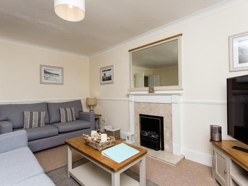 a living room with a couch and a fireplace at Peacehaven in Shalfleet
