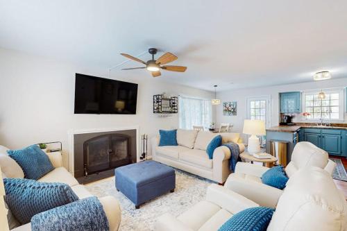 a living room with white furniture and a fireplace at 838 Ocean Parkway in Ocean Pines