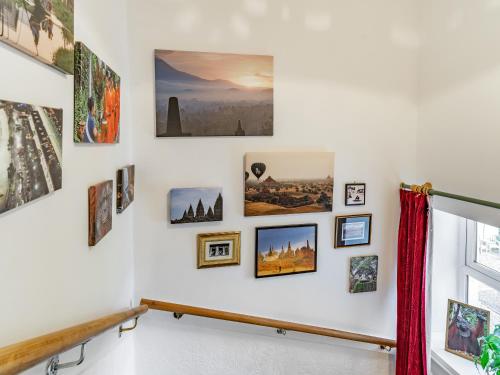 a wall of pictures and photographs on a wall at Number 4 in Llandeilo
