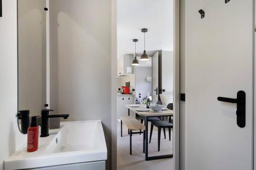 a kitchen and dining room with a sink and a table at Mobilehome Vallon 53 in Saint-Gervais