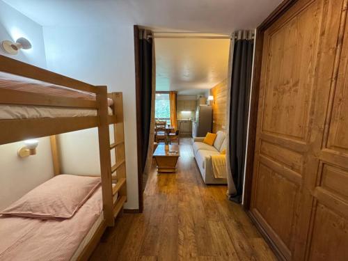a bedroom with a bunk bed and a living room at Artemis 402 2 chambres et coin montagne in Brides-les-Bains