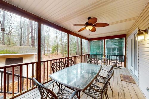 a screened in porch with a glass table and chairs at 22 Harpoon rd in Ocean Pines