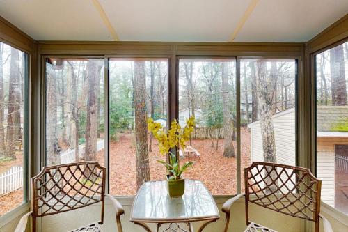 a room with a table and two chairs and a window at 22 Harpoon rd in Ocean Pines
