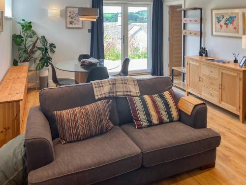 a living room with a couch and a table at Lower Mount Orchard in Stroud