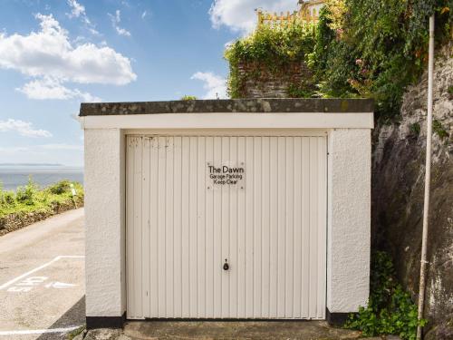 a white garage on the side of a road at The Dawn in Looe