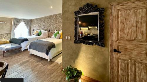a hotel room with two beds and a mirror at Loft Giofiel in Santeagueda