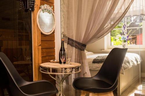 a room with two chairs and a table with a mirror at Paju Apartment in Võru