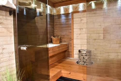 a shower with a glass door in a bathroom at Paju Apartment in Võru