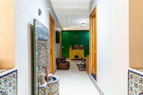 a hallway with a room with a green wall at Al manar in Oulad Akkou