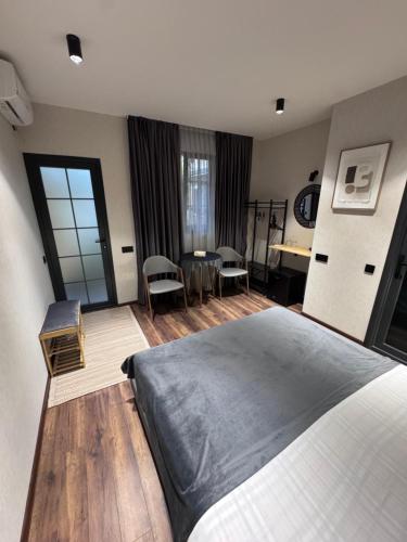 a bedroom with a bed and a table and chairs at Dream House in Yerevan