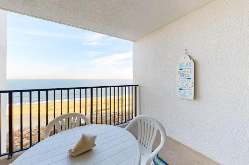 a white table and chairs on a balcony with the ocean at Pyramid 9G in Ocean City
