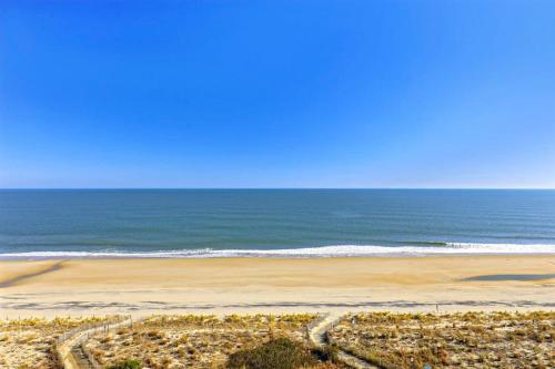 an empty beach with the ocean in the background at Pyramid 9G in Ocean City