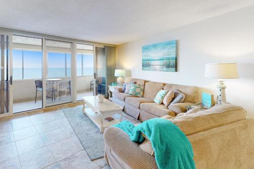 a living room with a couch and a table at Antigua 1004 in Ocean City